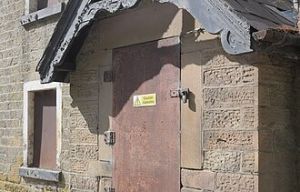 caution asbestos on building awaiting removal and disposal